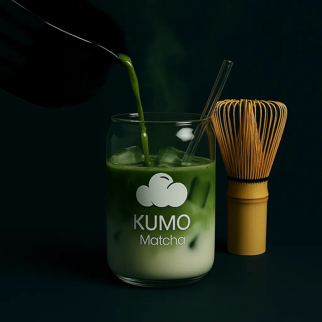 Matcha green tea being poured into a glass labeled 'KUMO Matcha' with a whisk on a dark background.