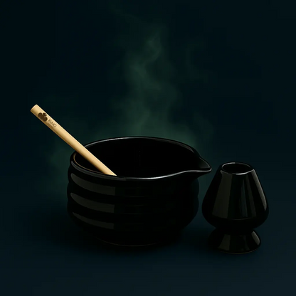 Black ceramic bowl with wooden tool and small black container on a dark background